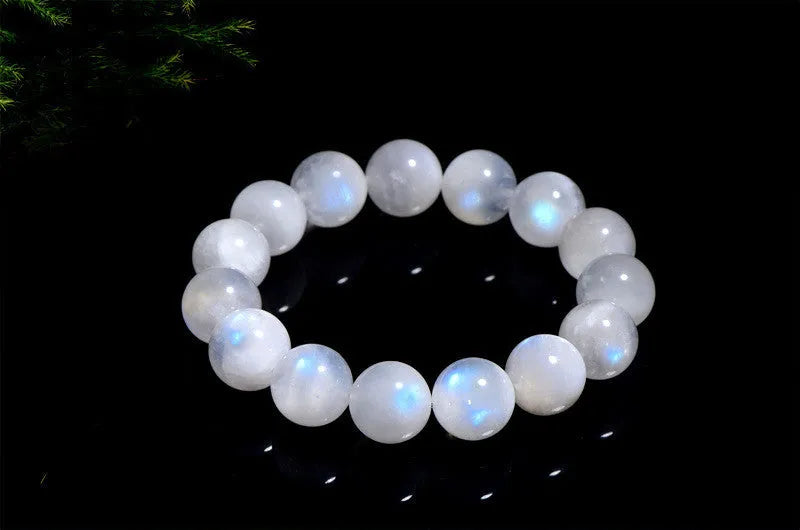 Natural blue moonlight moonstone round bead bracelet showing polished geometric beads on wrist