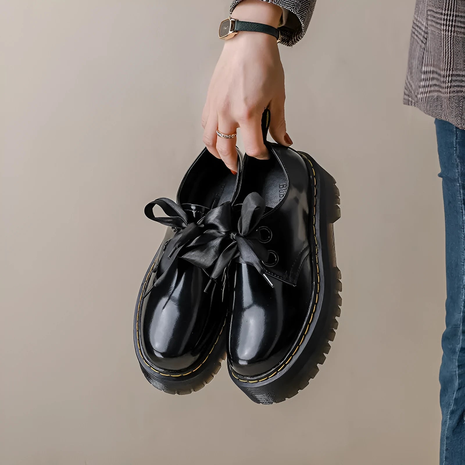 Women's black leather shoes with thick soles, ribbon cross-straps, and lace closure