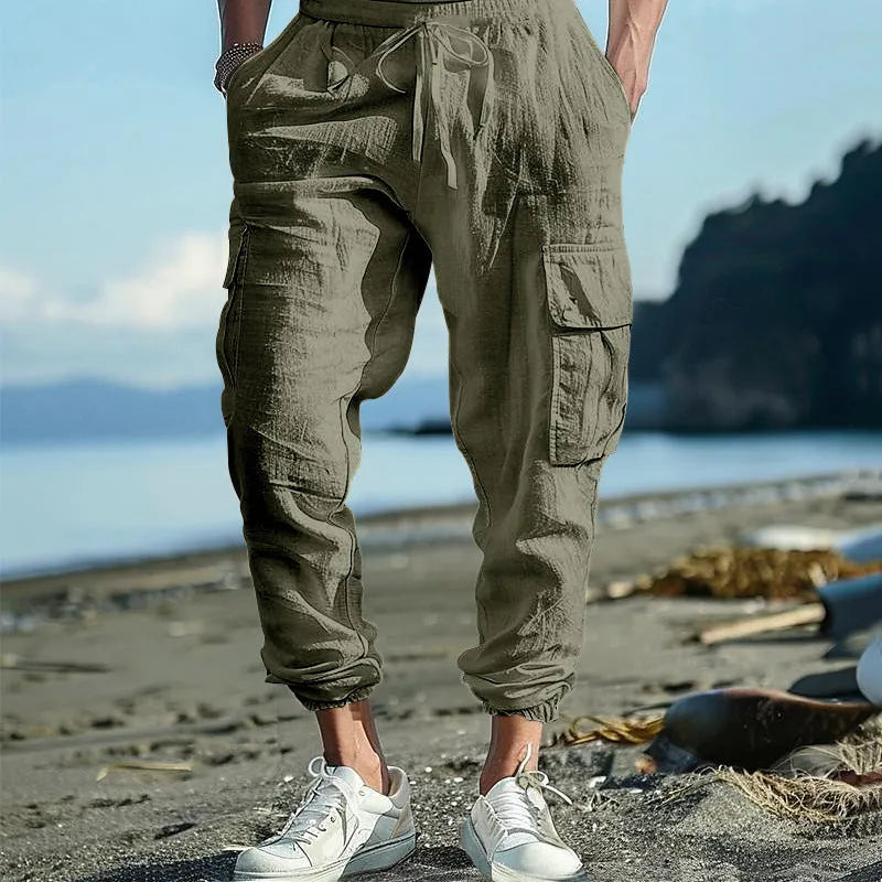 Men's loose-fit linen trousers with ankle-tied cuffs and multiple pockets.