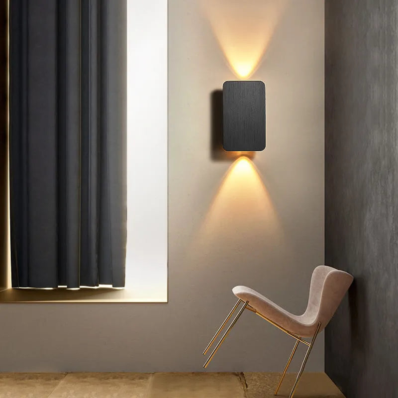 Minimalist modern LED wall lamp in black finish mounted on a wall