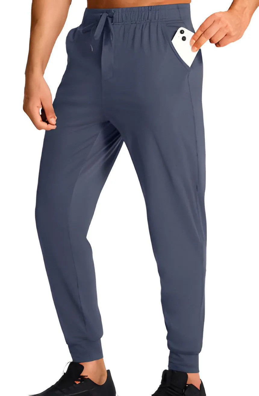 Men's loose-fit solid colour casual trousers on a hanger, showing the relaxed leg cut.