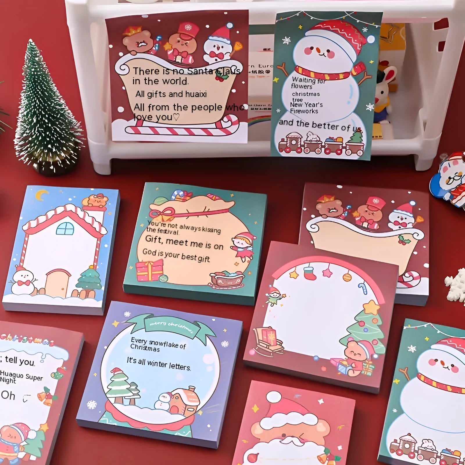 Christmas sticky notes book showing cartoon designs of Elf, Gift, Sled, Ball, Santa, House, Bear, and Snowman