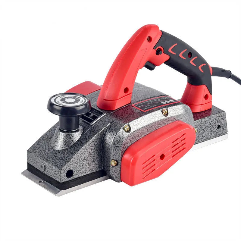 Red desktop electric wood planer with aluminium housing showing 82mm cutting width
