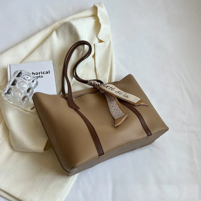 Soft large capacity tote bag with crossbody strap in khaki colour showing outer pocket and sewing line detail