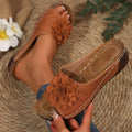 Women's peep-toe slipper in black with a thick rubber sole and PVC upper, showing the fish mouth toe opening.