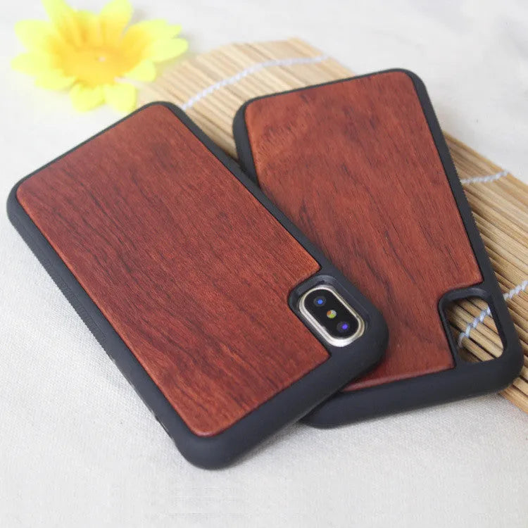 Wooden iPhone case with carbonized bamboo back and black TPU bumper frame on a table.