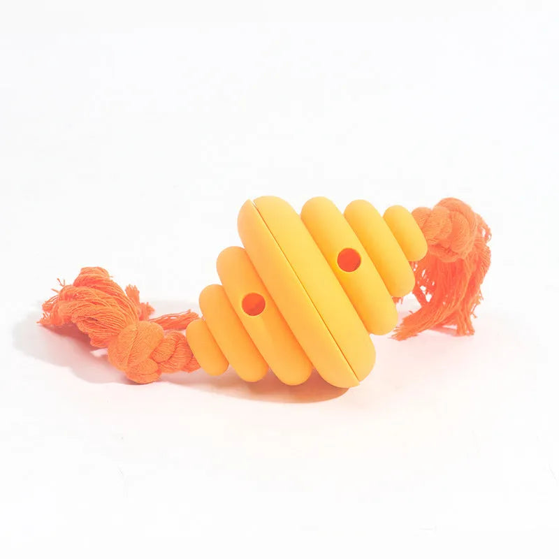 Green and yellow silicone dog ball with rope handle for tug-of-war and treat dispensing