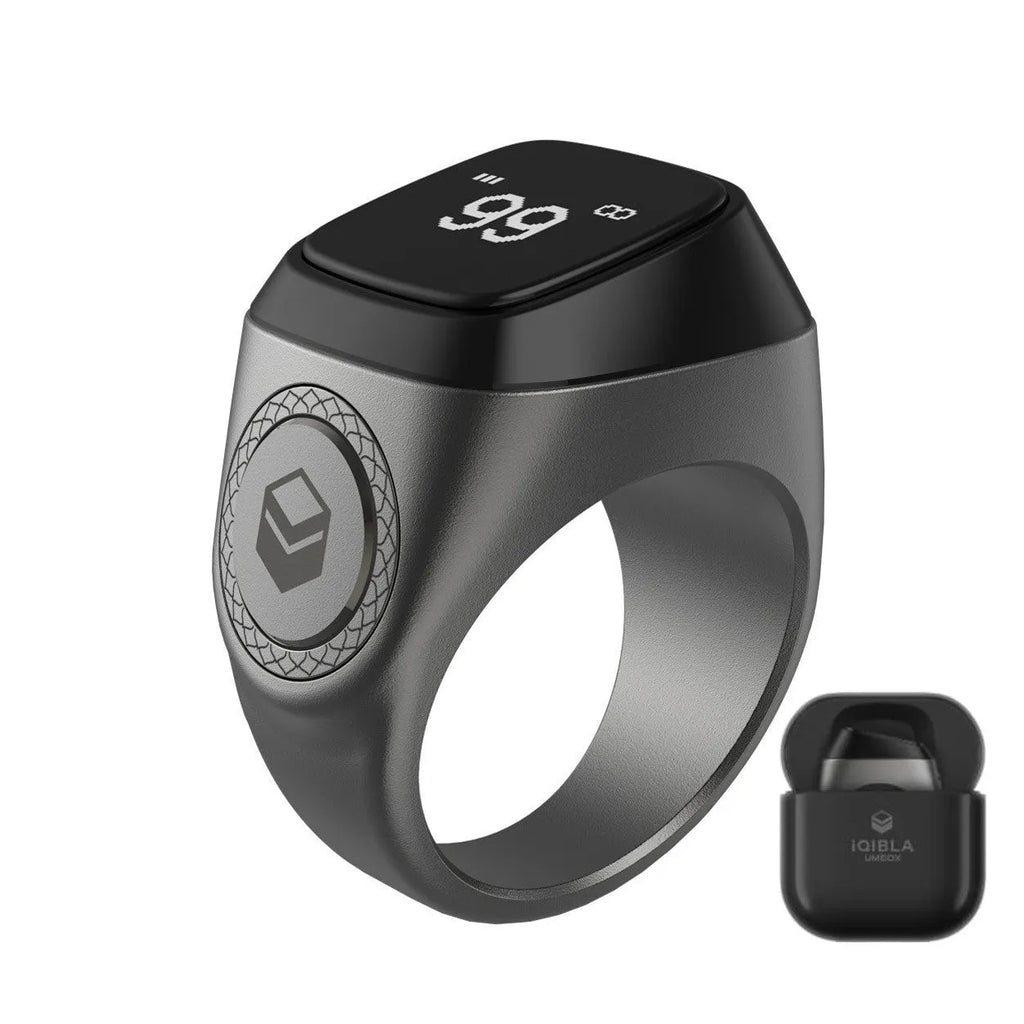 Zikr1 Lite Tasbih smart ring in silver on a charging case with USB cable.
