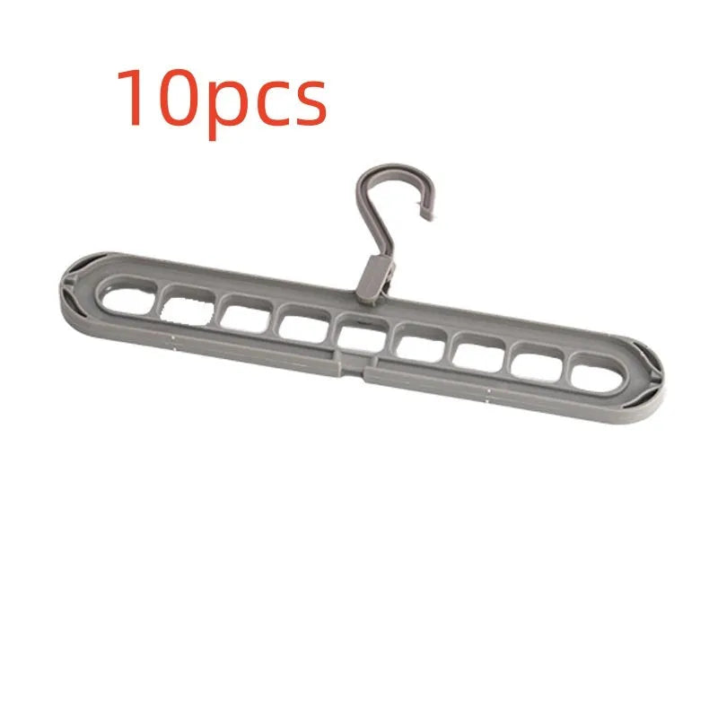 A green plastic multifunctional hanger with nine holes for trousers, shown in a folded and unfolded position.