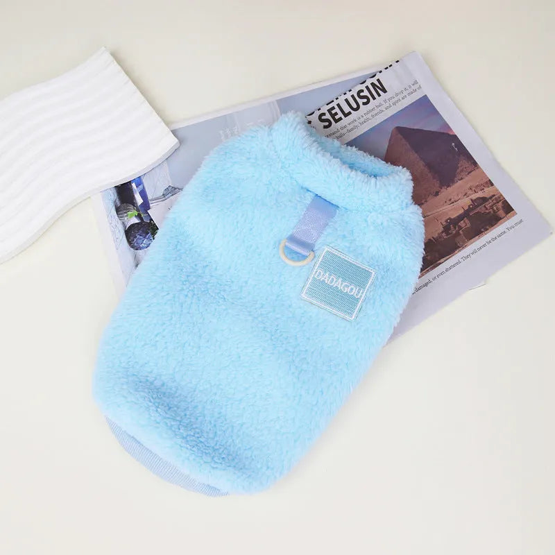 Blue coral fleece jacket for a dog, showing front leg openings and fluffy texture.