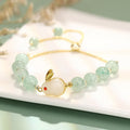 Rabbit charm bracelet with green aventurine or strawberry quartz beads on a gold-coloured adjustable chain.