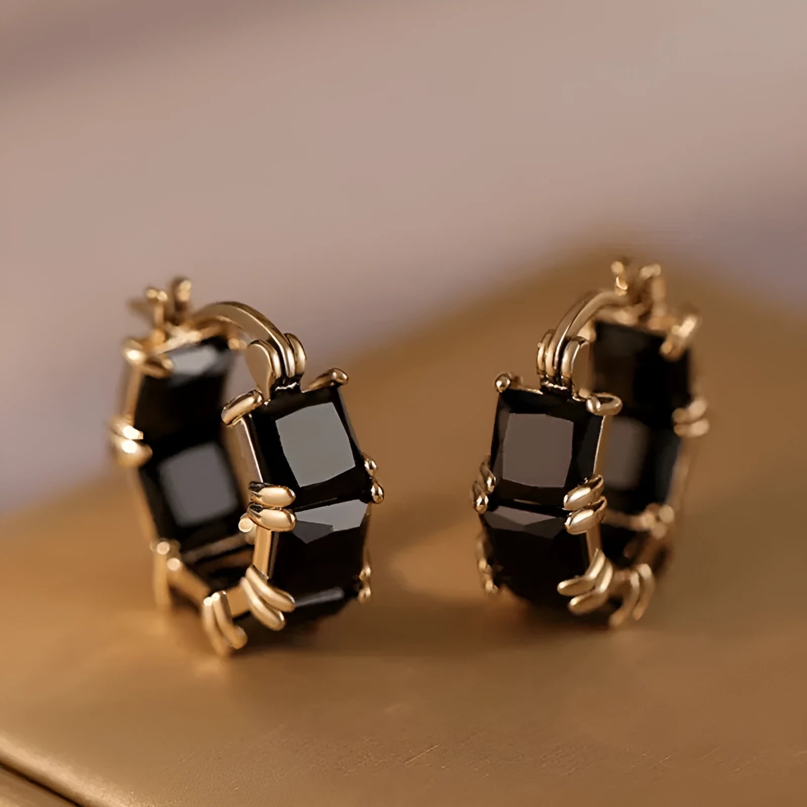 Geometric U-shaped gold earrings with round accents and black zircon stones
