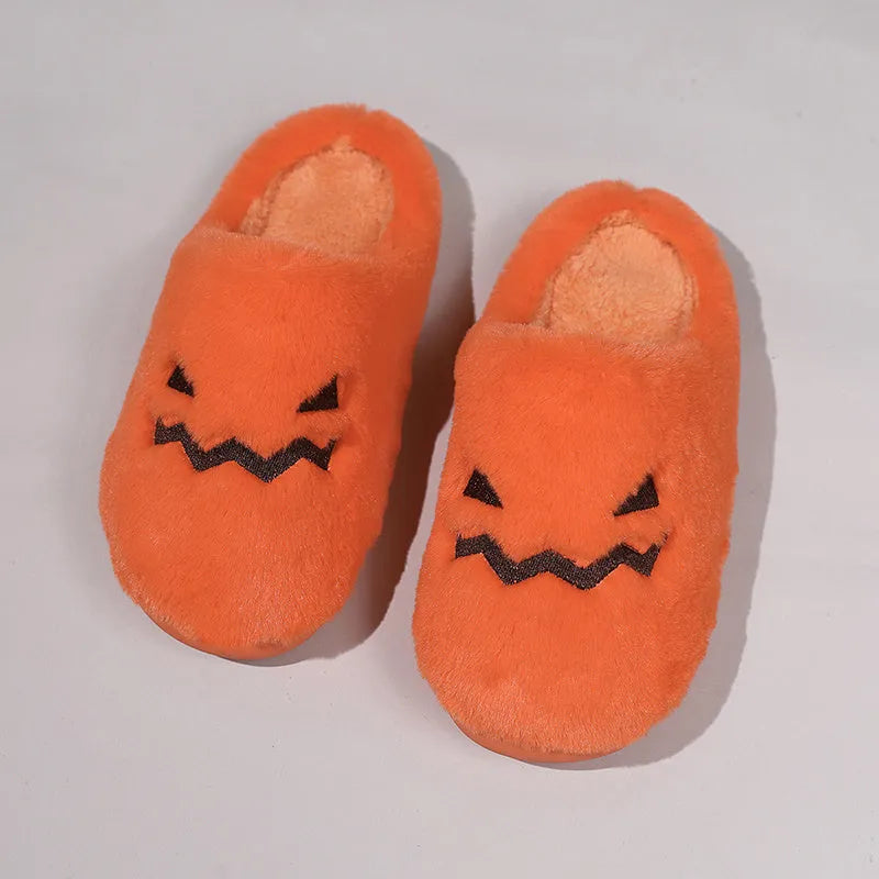 Orange pumpkin-themed plush slippers with a non-slip sole for indoor home wear.