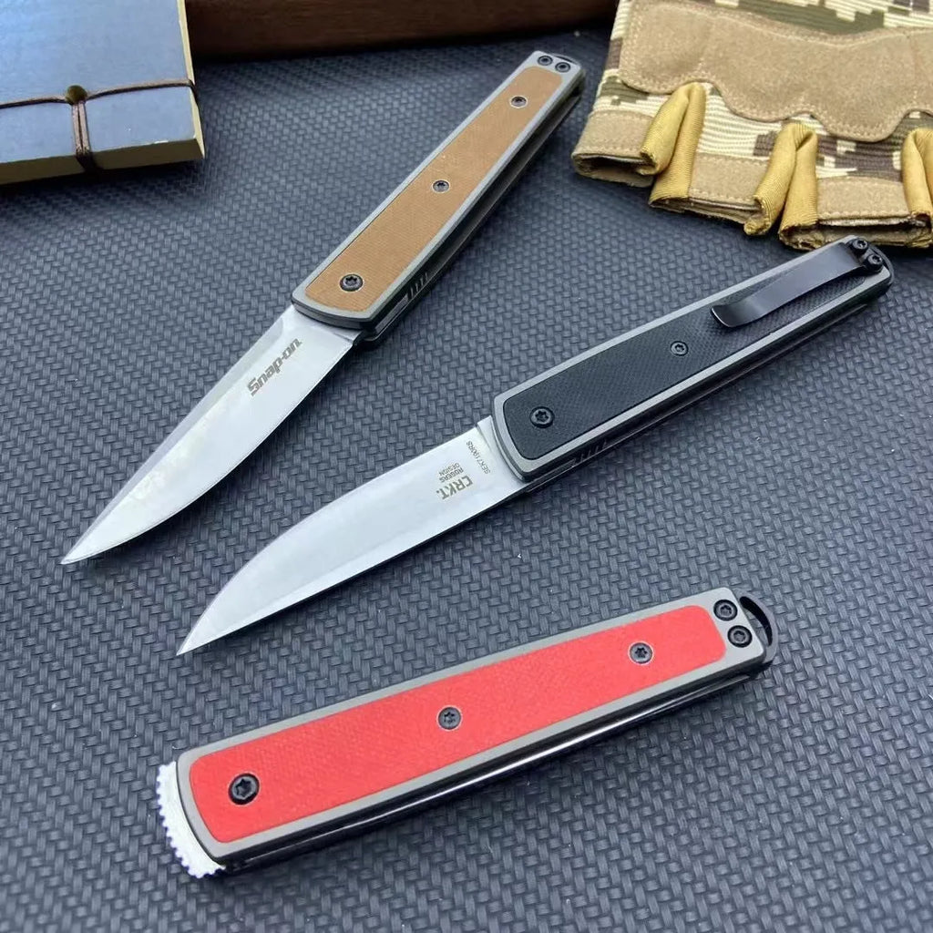 Folding fruit knife with stainless steel blade in black, brown, or red colour options showing closed and open positions