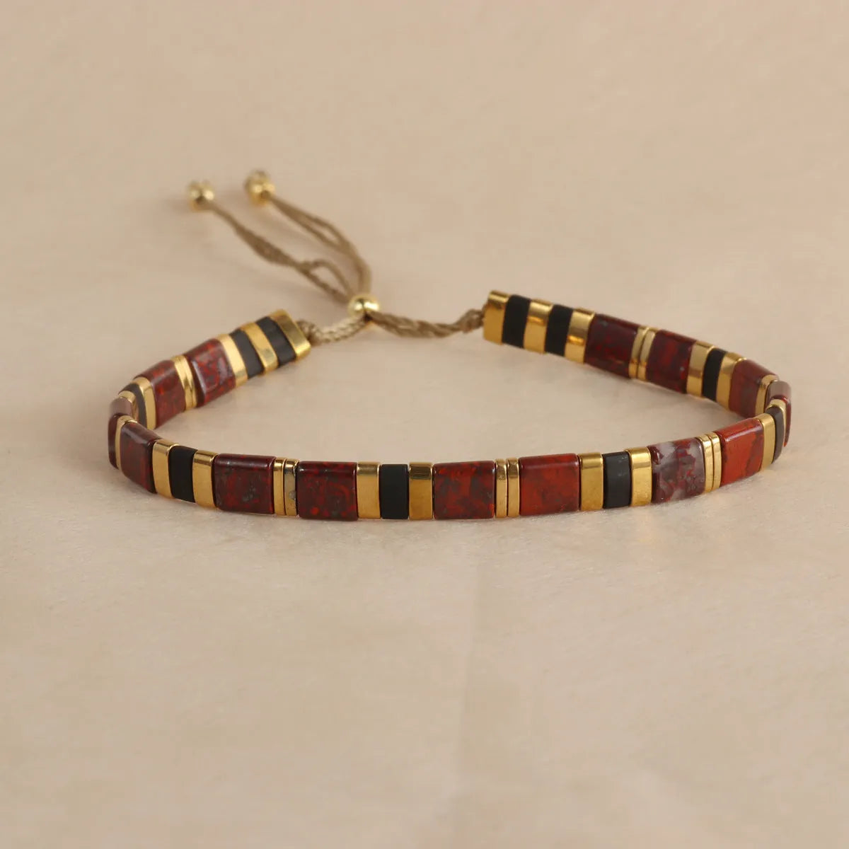 Geometric pull bead bracelet with round glass beads in multiple colour options.