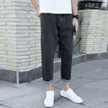 Men's loose straight leg blue cotton jeans with a college style on a casual background.