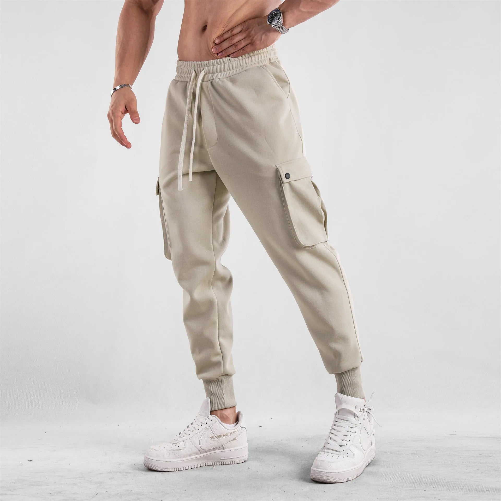 Men's loose light gray cotton trousers with ankle-tied cuffs and multiple pockets