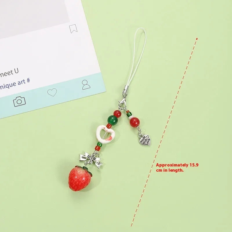 Plastic resin fruit charm keychain with removable rope in strawberry, green apple, and red apple designs.