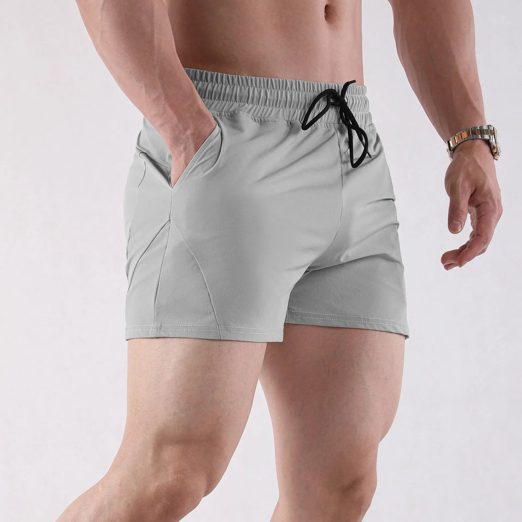 Men's thin grey polyester basketball shorts with elastic waistband on a plain background.