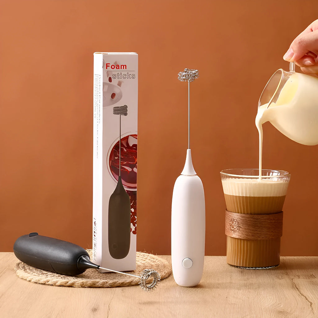 Handheld electric milk frother in black and white colours for making coffee and hot chocolate foam.