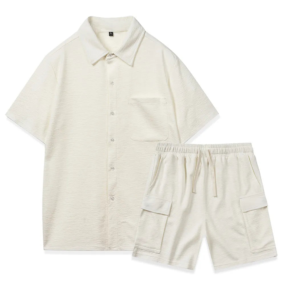 Women's black polyester two-piece set with short sleeve top and elastic waist shorts laid flat.
