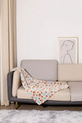 Blue cartoon dog paw patterned flannel pet blanket laid flat, showing its size.