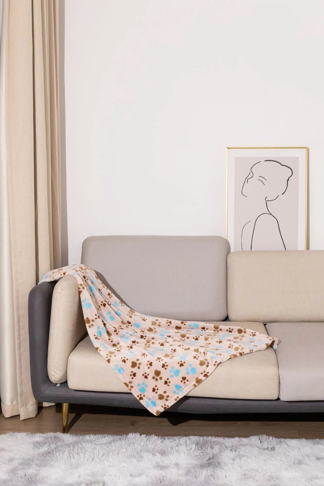 Blue cartoon dog paw patterned flannel pet blanket laid flat, showing its size.