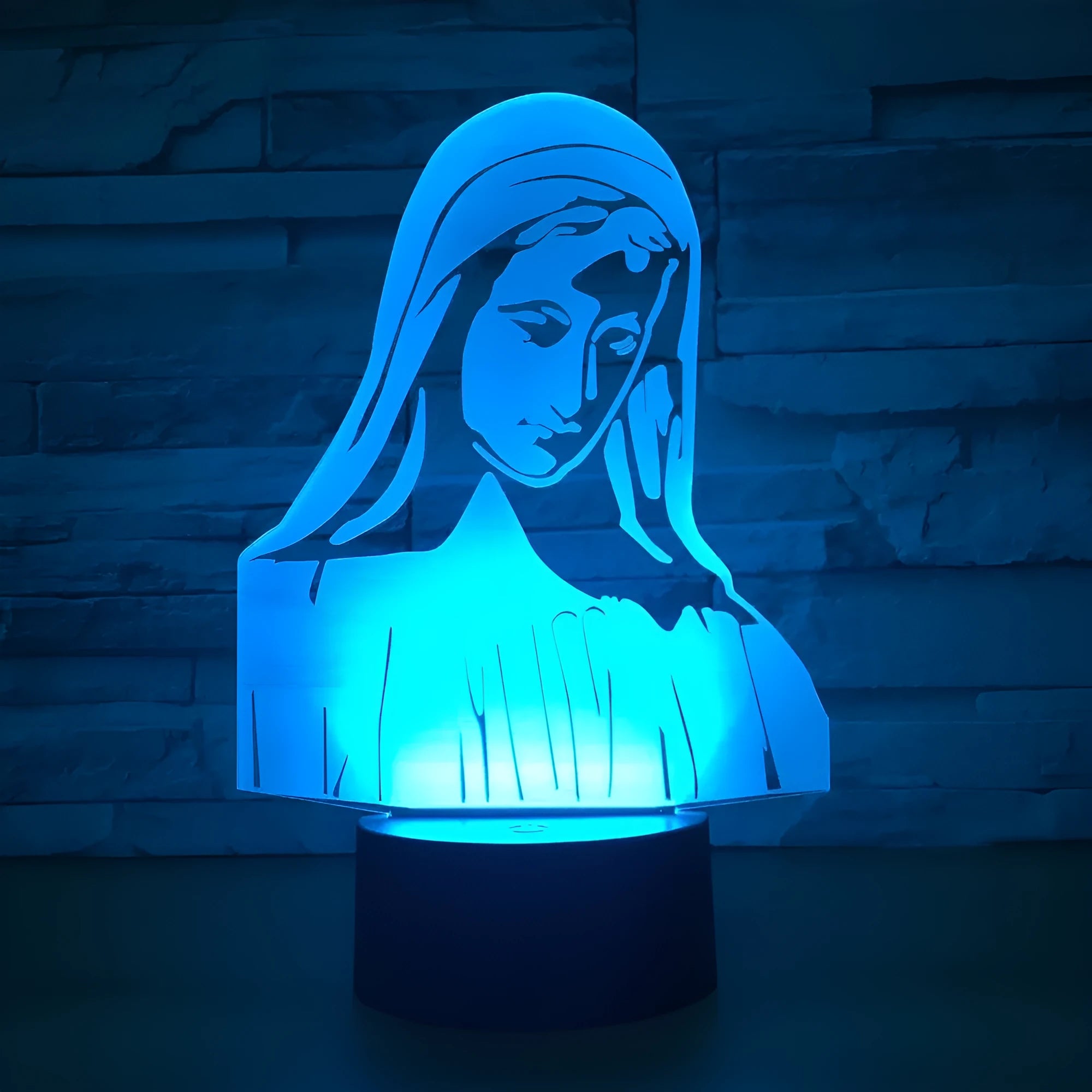 3D LED night light with dual ring pattern glowing in colour on ABS base