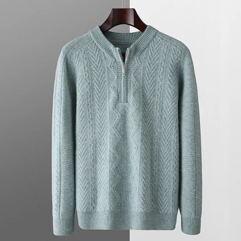 Man wearing a milky white half-zip wool sweater with a diamond pattern, showing loose fit and long sleeves.