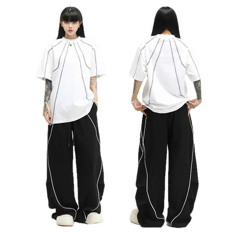 Black wide-leg trousers with vertical stripes and a pleated mid-waistband.