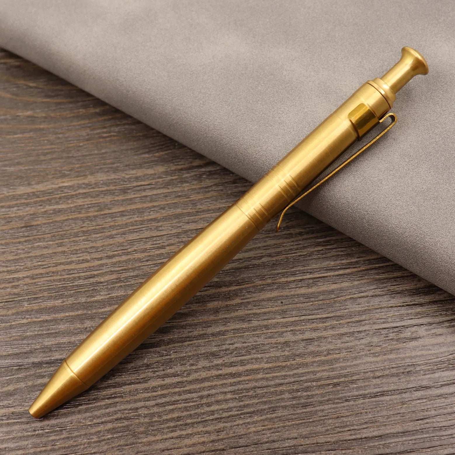 Brass tactical pen with bolt-action mechanism and retro brushed finish
