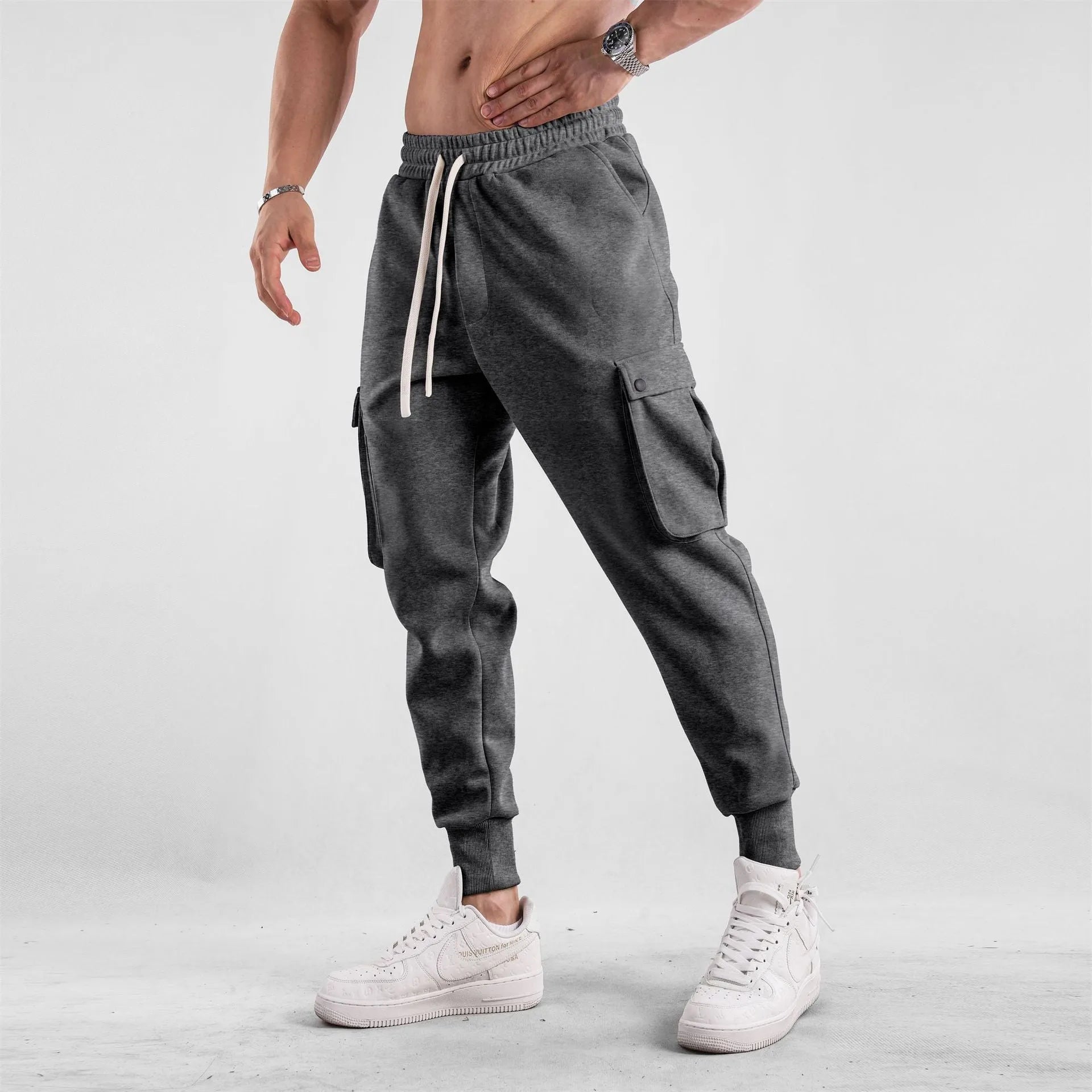 Men's loose light gray cotton trousers with ankle-tied cuffs and multiple pockets