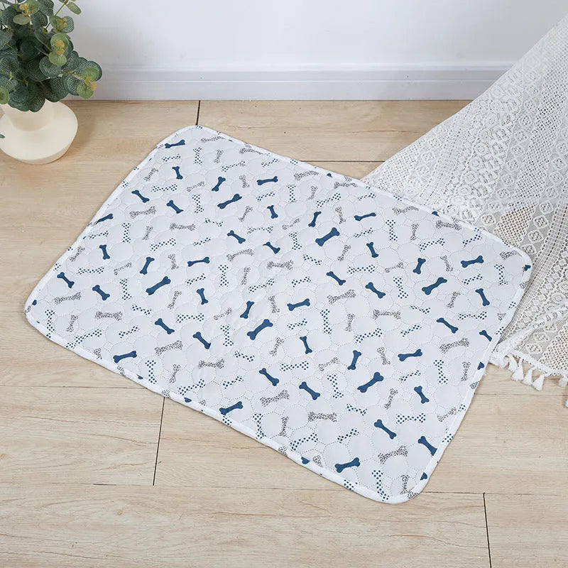 Reusable washable pet urine pad with colourful animal print and waterproof non-slip backing.
