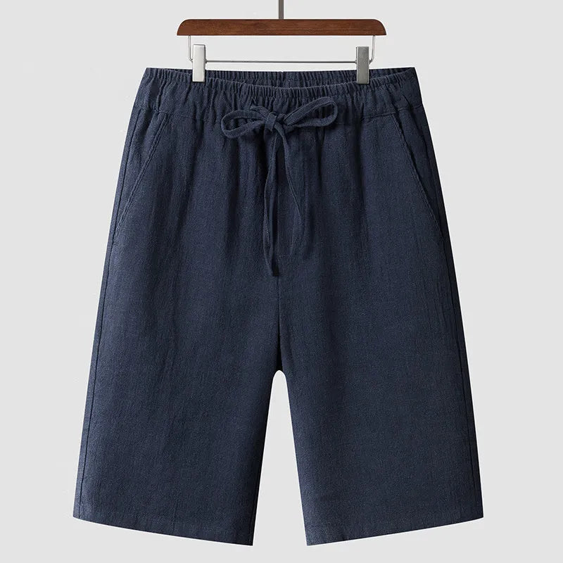 Men's linen shorts in loose cropped design with elastic waistband, shown in available colours