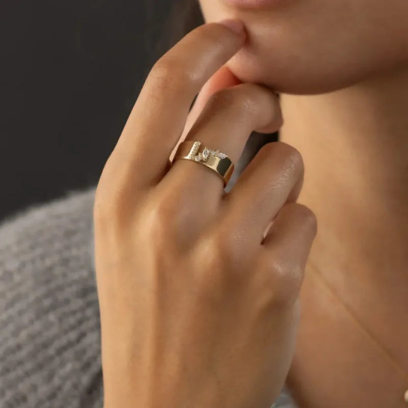 Gold electroplated zircon ring on finger showing shining finish and decorative detail