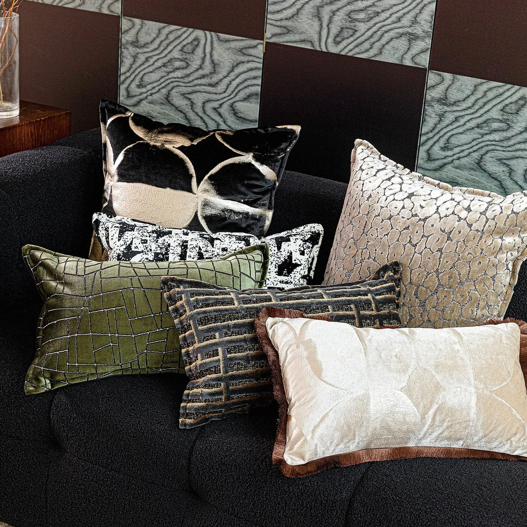 Black and gold abstract patterned decorative cushion on a sofa, available in three sizes with a removable cover.