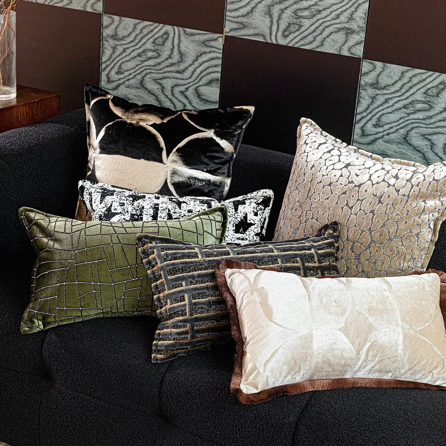 Black and gold abstract patterned decorative cushion on a sofa, available in three sizes with a removable cover.