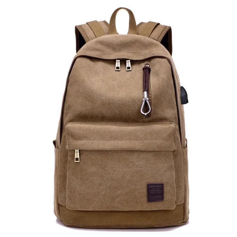 Canvas backpack with USB charging port showing computer compartment and zipper pocket