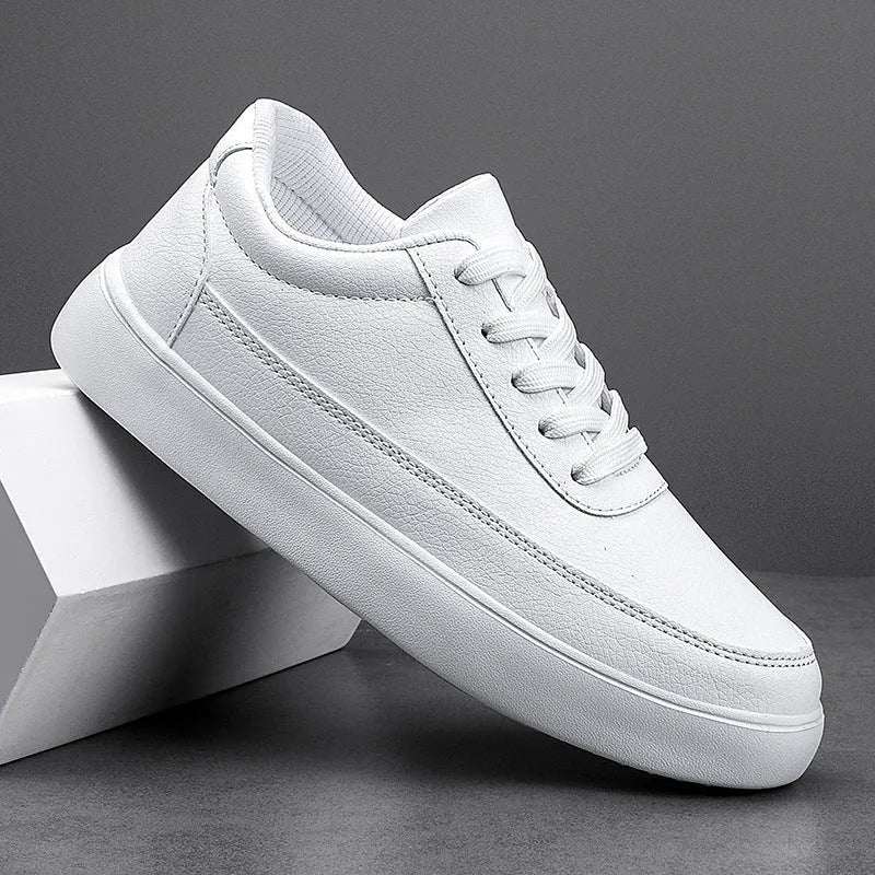 Women's white leather flat casual lace-up shoes on a neutral background.