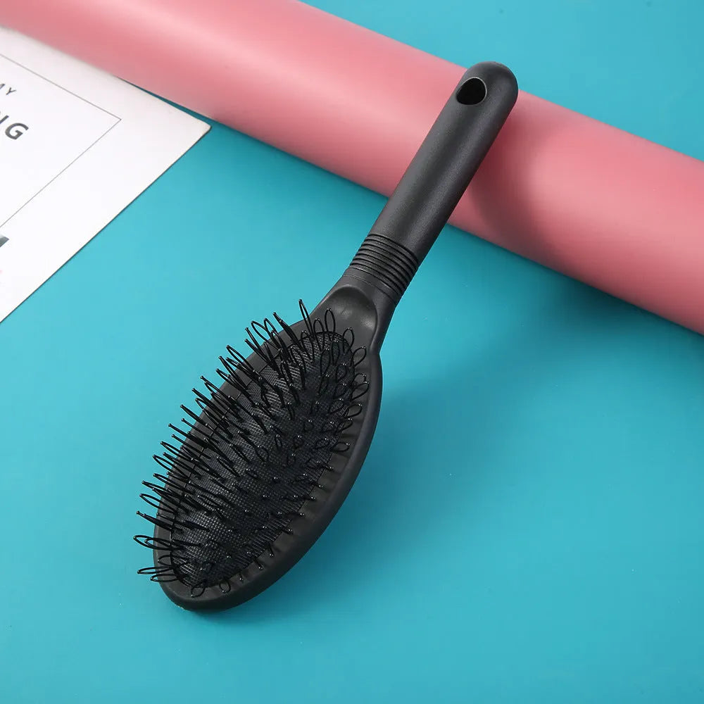Black and pink ABS plastic hair extension comb with ring teeth measuring 22cm by 6cm