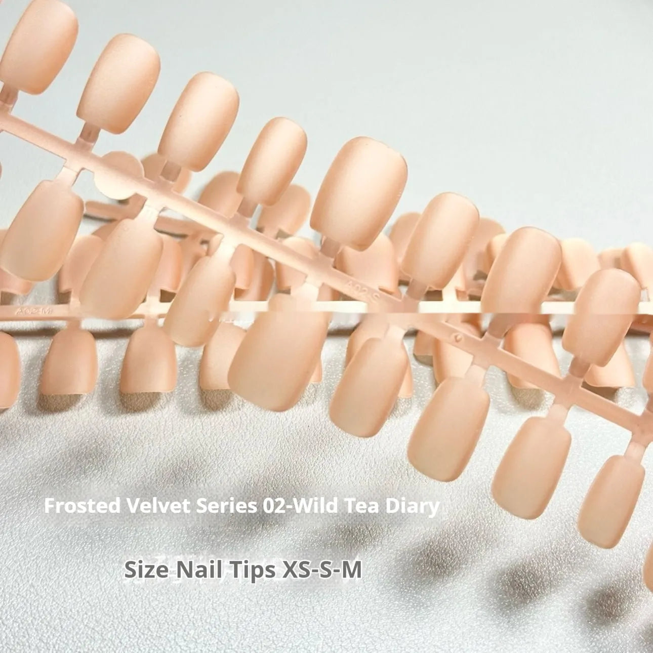 Set of velvet frosted Cat's Eye effect false nails in short ladder sizes on a clear background.