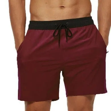 Men's blue fitness shorts with stitching waist detail, drawstring, and multiple pockets for gym workouts