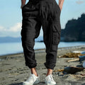 Men's loose-fit linen trousers with ankle-tied cuffs and multiple pockets.