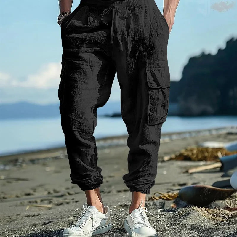 Men's loose-fit linen trousers with ankle-tied cuffs and multiple pockets.