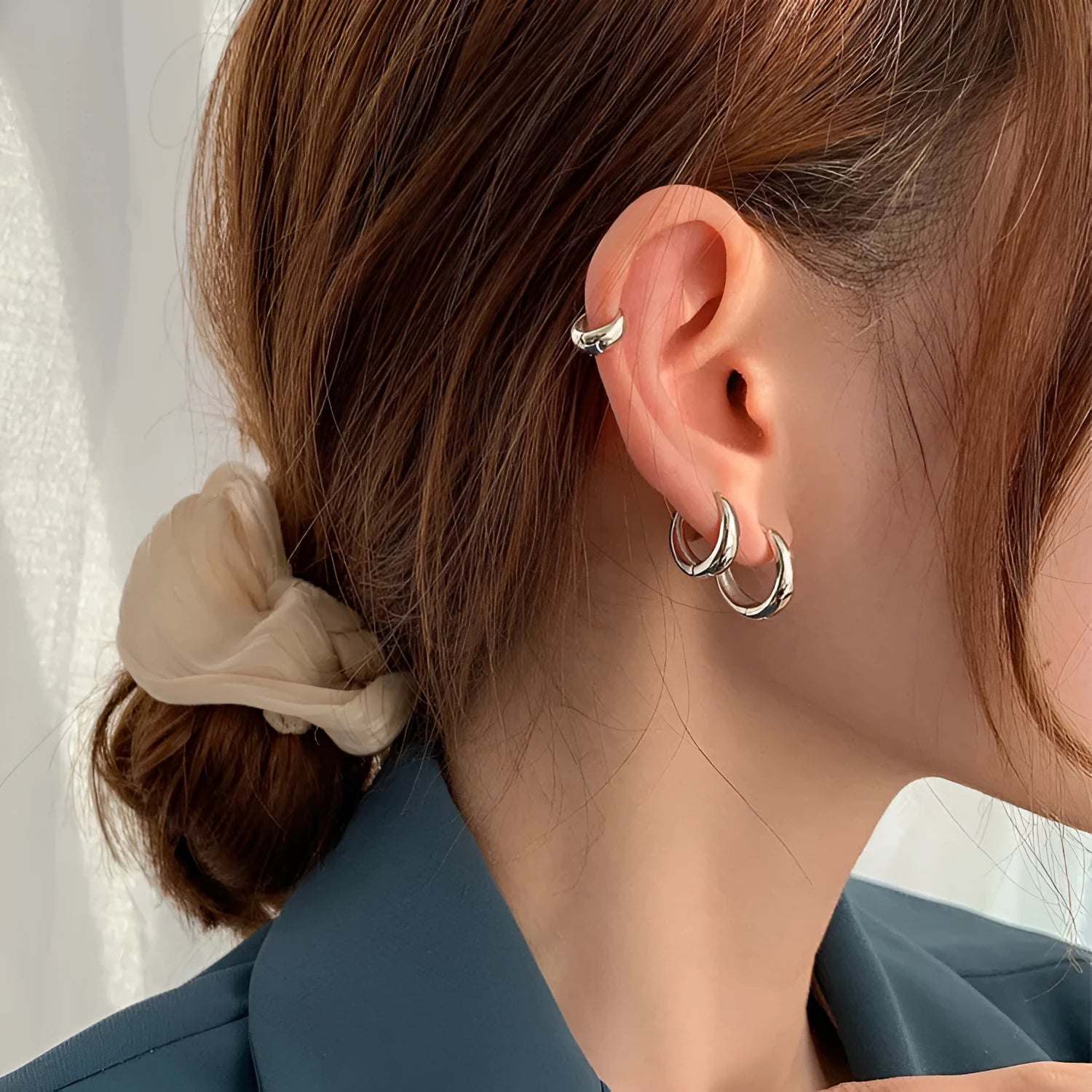 Women's geometric water drop earrings in gold and silver with minimalist round design