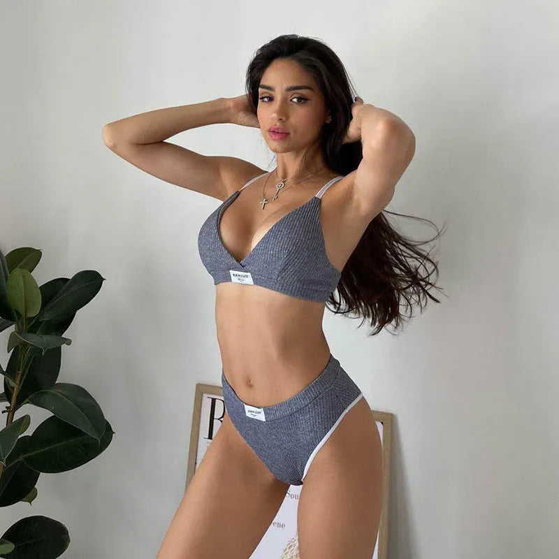Grey women's bikini set with white contrast binding and embroidery detail on the top.