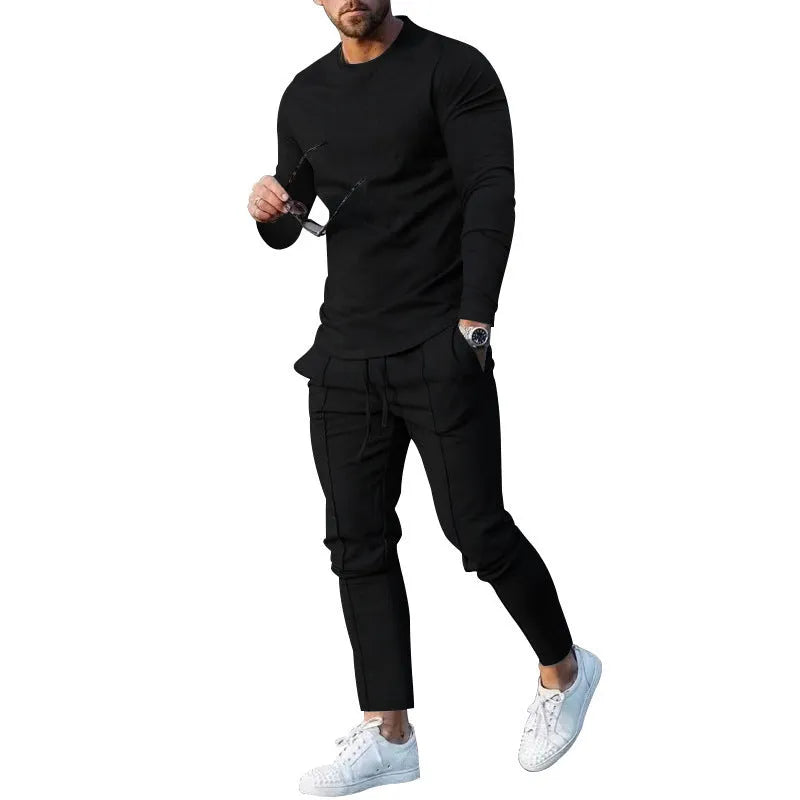 Men's light grey polyester two-piece suit with long sleeve round neck T-shirt and matching trousers laid flat.