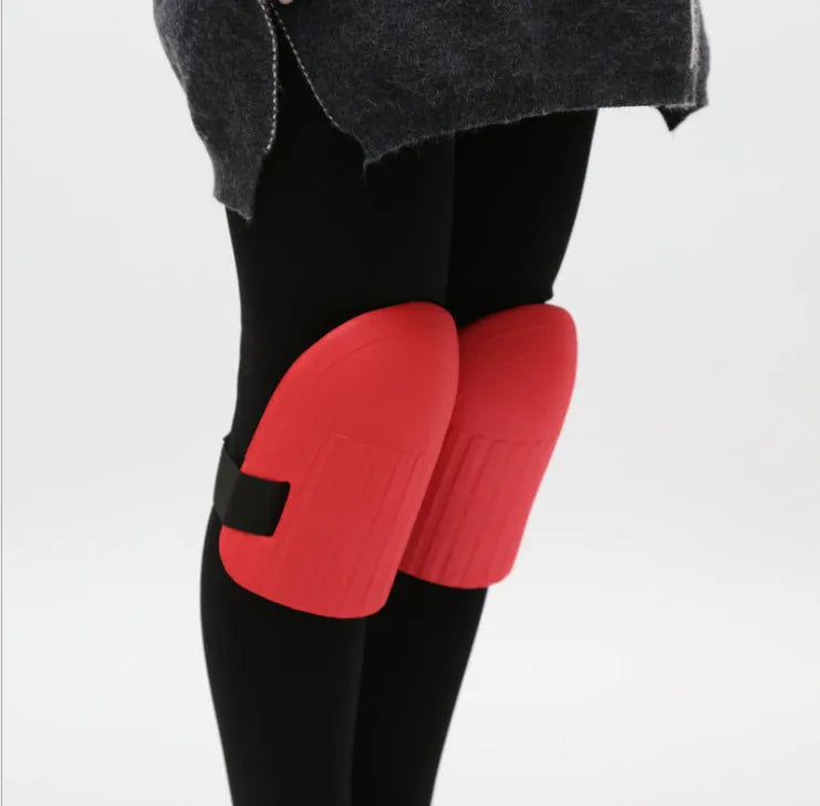 A pair of black EVA foam knee pads for gardening, showing their rectangular shape and textured surface.