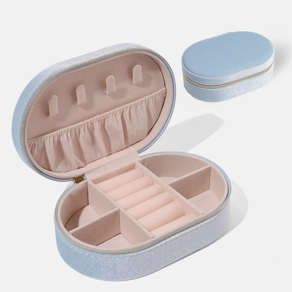 Oval velvet jewelry storage box in lake blue colour showing compact 15x10x5cm dimensions with flannel interior