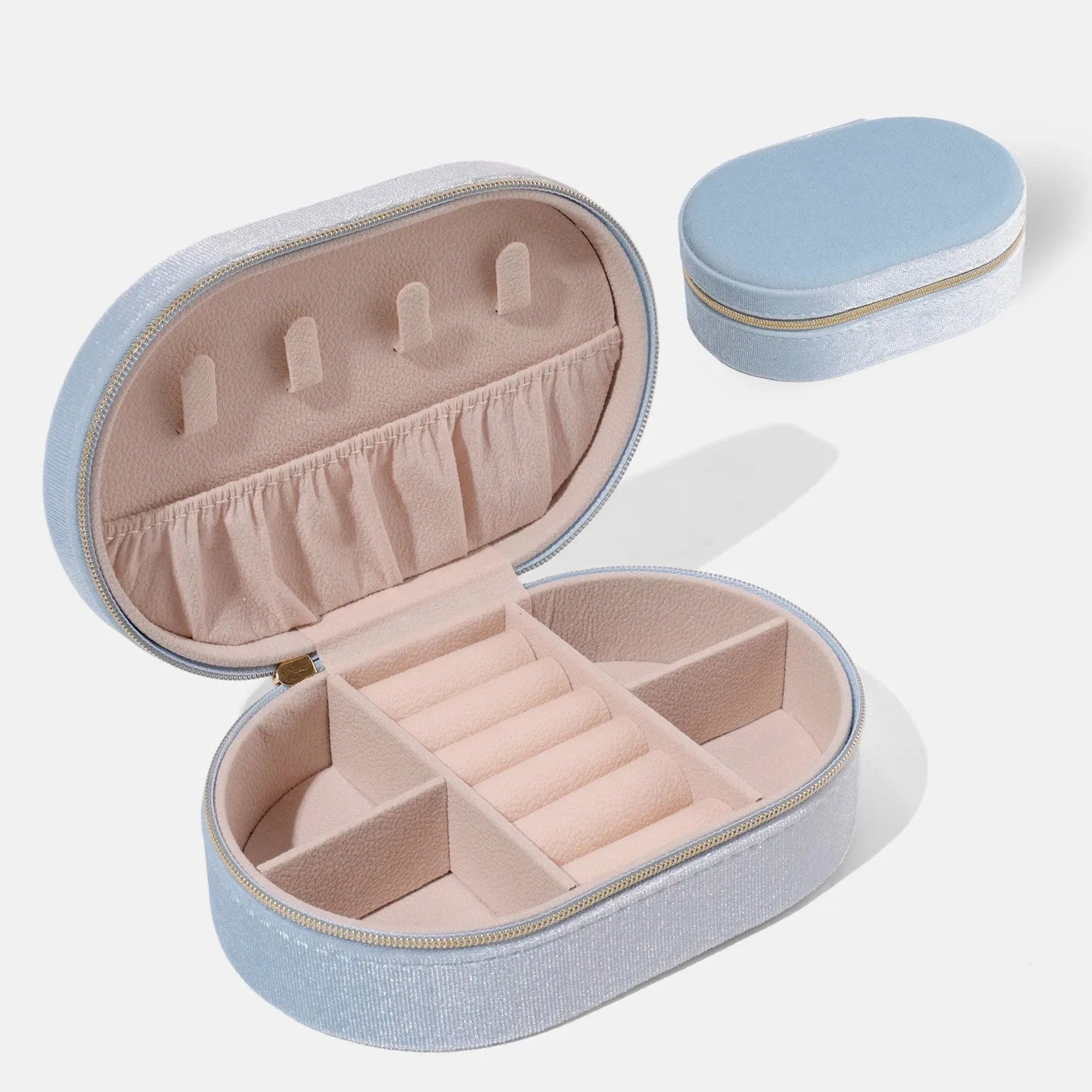 Oval velvet jewelry storage box in lake blue colour showing compact 15x10x5cm dimensions with flannel interior